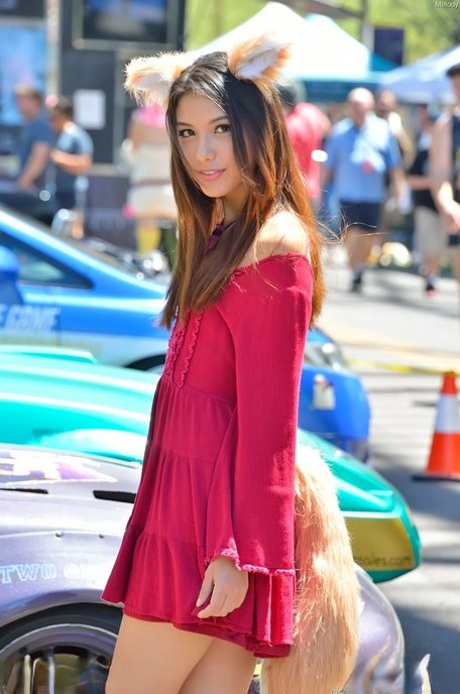 Glamour babe in a beautiful dress Melody teasing with sexy upskirt in public